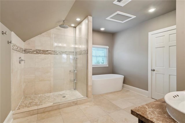 bathroom featuring tile patterned flooring, vaulted ceiling, and shower with separate bathtub