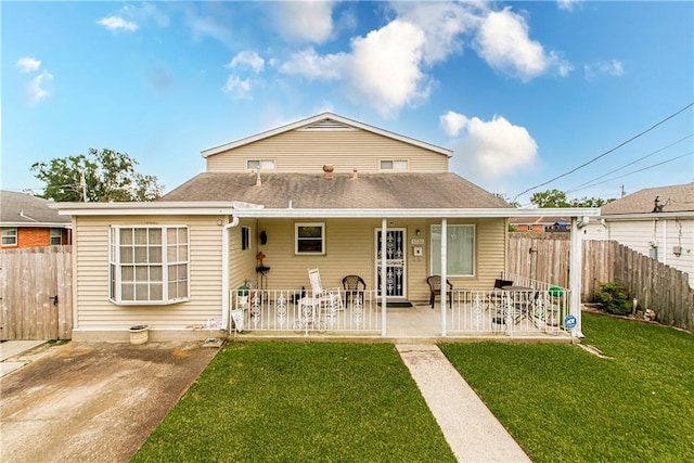 back of property with a lawn and a patio area