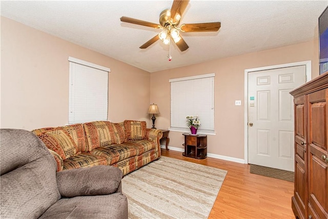 living room featuring light hardwood / wood-style floors and ceiling fan