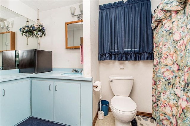 bathroom featuring vanity and toilet