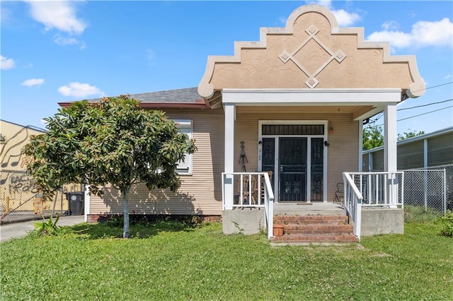 view of front of home featuring a front yard and covered porch