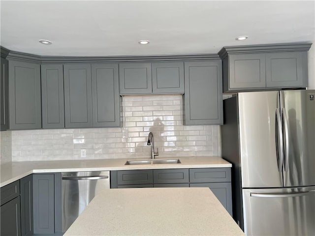 kitchen with sink, appliances with stainless steel finishes, tasteful backsplash, and gray cabinets