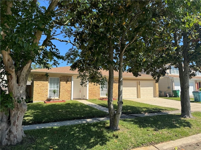 view of front of home with a garage and a front lawn