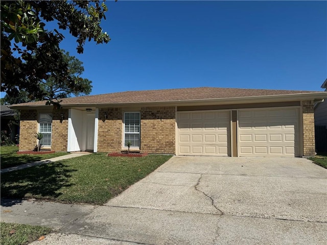 ranch-style home with a garage and a front yard