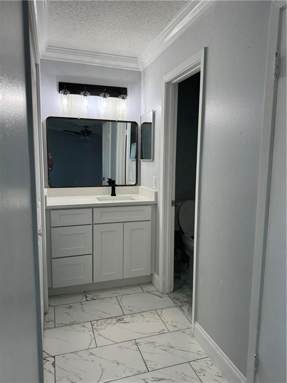 bathroom with vanity, tile floors, crown molding, and a textured ceiling