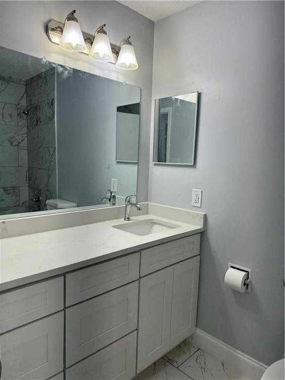 bathroom featuring toilet, tile flooring, and vanity