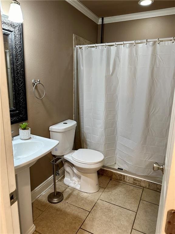 bathroom with crown molding, toilet, and tile flooring