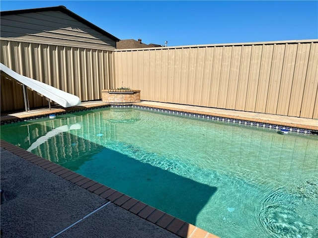 view of pool with a water slide