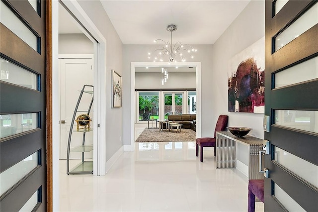 tiled entryway featuring a chandelier