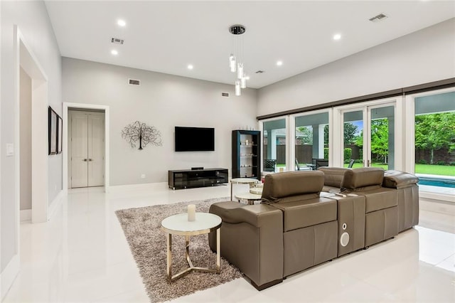 tiled living room with a towering ceiling