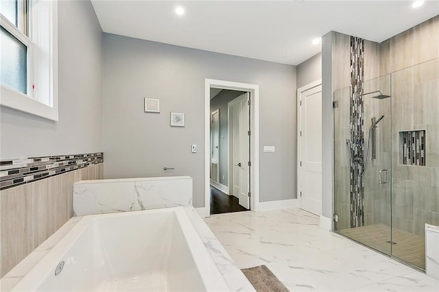 bathroom with tile walls, separate shower and tub, and tile flooring