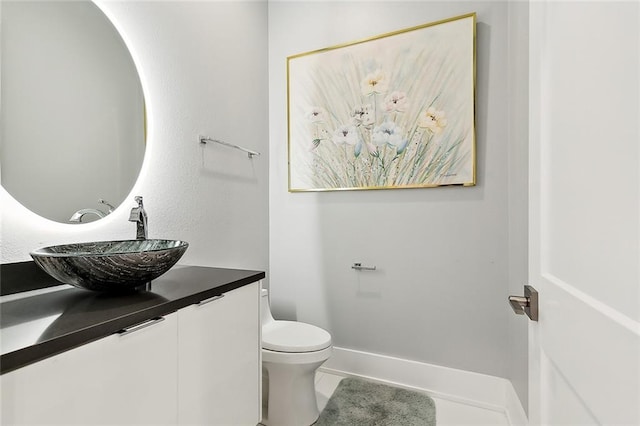 bathroom featuring vanity, toilet, and tile flooring