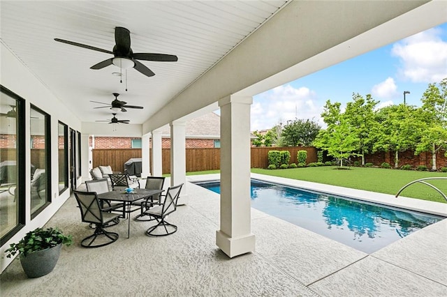 view of pool featuring a patio, a yard, and ceiling fan