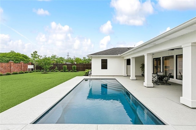 view of pool featuring a lawn, ceiling fan, and a patio area