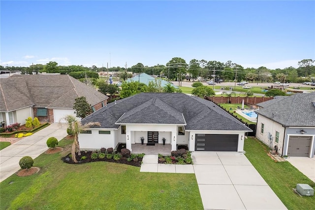 single story home with a front yard and a garage