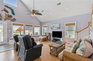 living room with ceiling fan, high vaulted ceiling, and light wood-type flooring