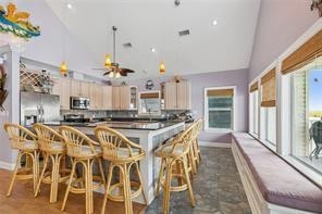 kitchen featuring light brown cabinetry, a healthy amount of sunlight, stainless steel appliances, and ceiling fan