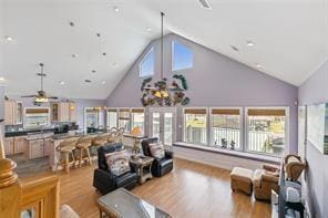 living room featuring high vaulted ceiling, ceiling fan, and hardwood / wood-style flooring