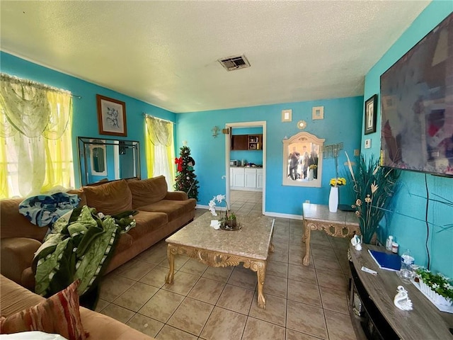 living room with light tile patterned floors and a textured ceiling