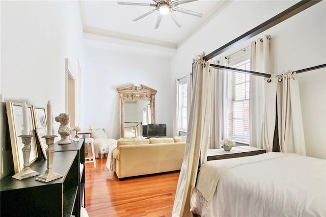 bedroom featuring ornamental molding, hardwood / wood-style floors, and ceiling fan