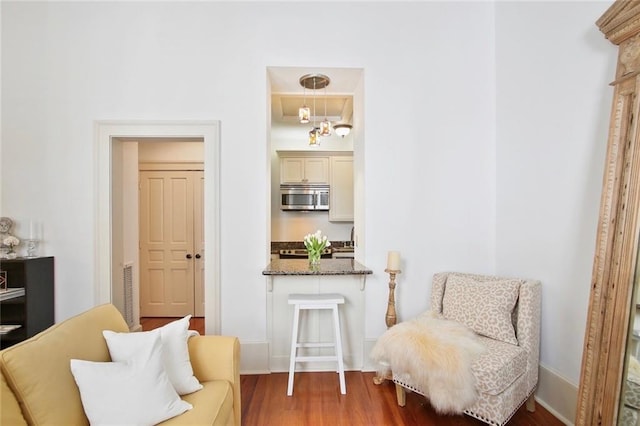 living area with a chandelier and hardwood / wood-style flooring