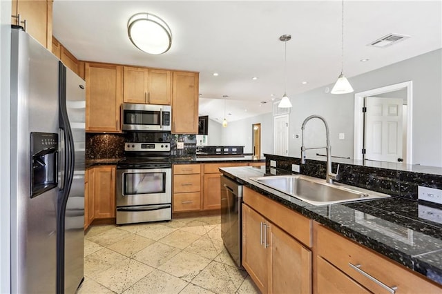 kitchen with decorative light fixtures, backsplash, stainless steel appliances, light tile floors, and sink