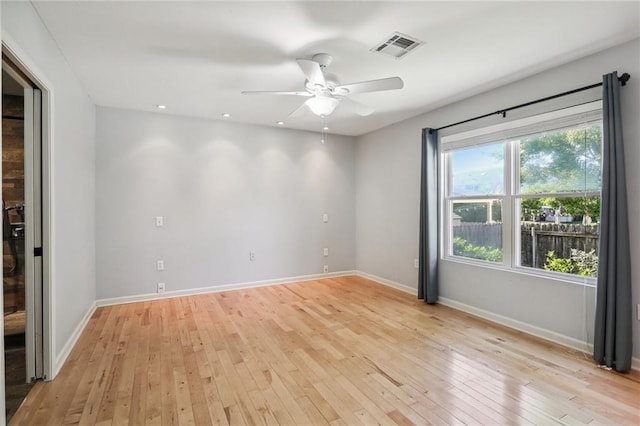 spare room featuring light hardwood / wood-style flooring and ceiling fan