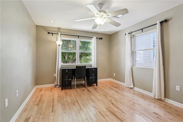 unfurnished office featuring ceiling fan and light wood-type flooring