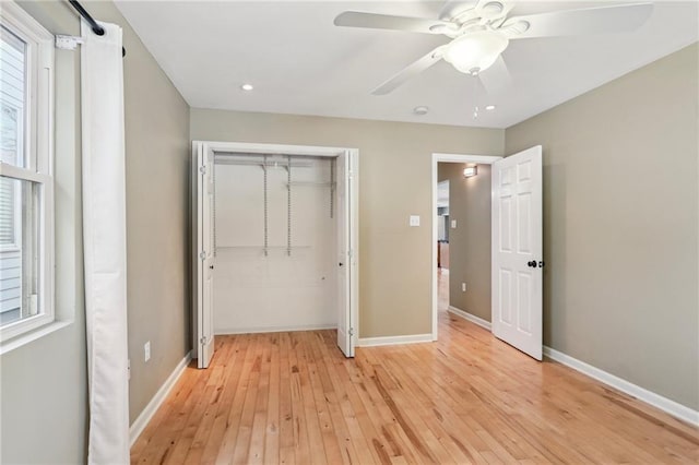 unfurnished bedroom with a closet, light hardwood / wood-style flooring, and ceiling fan