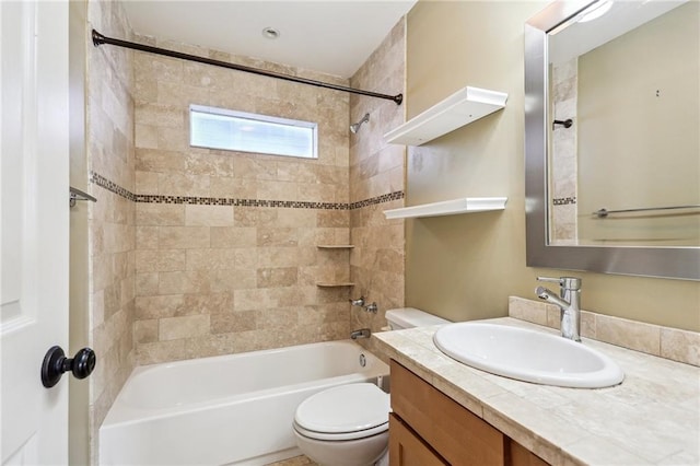 full bathroom with vanity, toilet, and tiled shower / bath combo