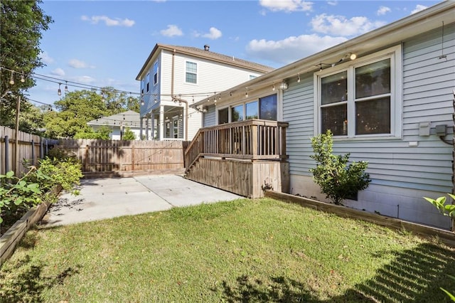 rear view of house featuring a lawn and a patio area