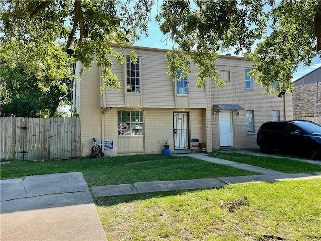 multi unit property featuring a front lawn