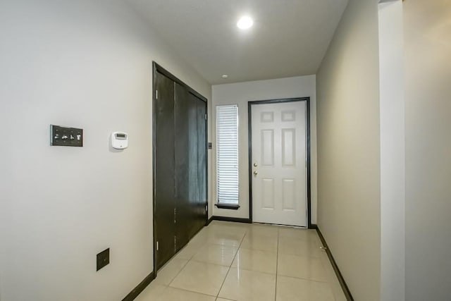 doorway to outside with light tile patterned floors