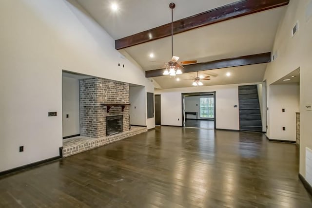 unfurnished living room featuring beamed ceiling, ceiling fan, high vaulted ceiling, a brick fireplace, and dark hardwood / wood-style flooring