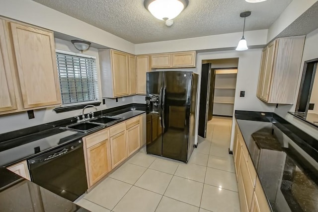 kitchen featuring black appliances and light brown cabinets