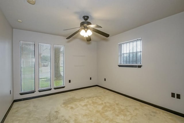 empty room with ceiling fan and carpet floors