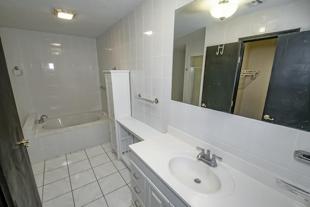 bathroom featuring vanity, backsplash, tile walls, and tile patterned floors