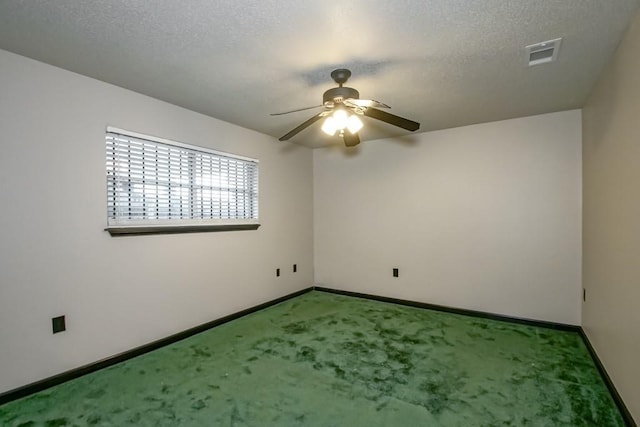 carpeted spare room featuring a textured ceiling and ceiling fan