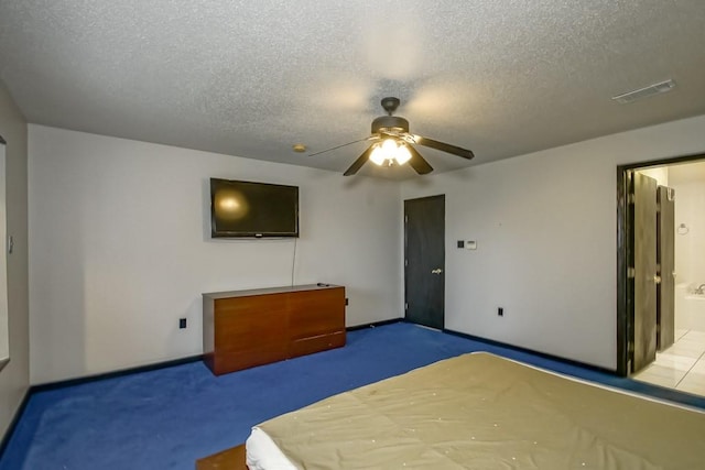 unfurnished bedroom featuring a textured ceiling, carpet flooring, ceiling fan, and ensuite bathroom