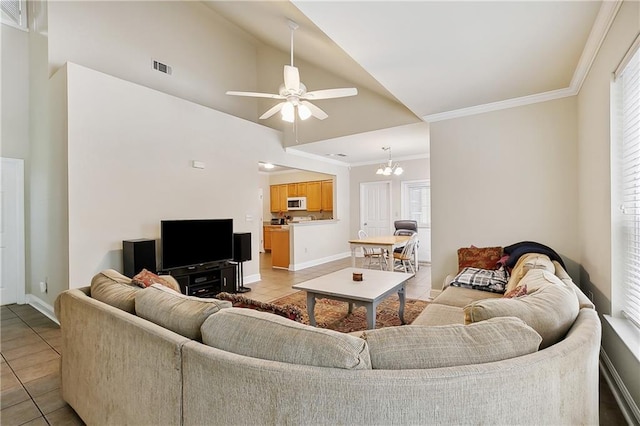 living room with baseboards, visible vents, light tile patterned flooring, crown molding, and ceiling fan with notable chandelier