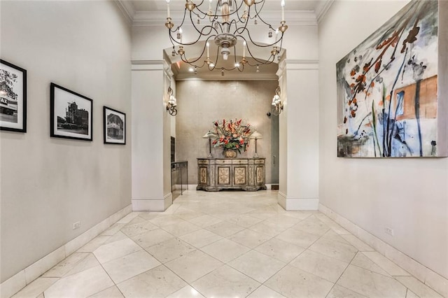 hallway with light tile flooring, a towering ceiling, an inviting chandelier, and ornamental molding