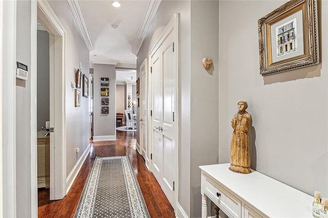 hallway featuring ornamental molding and dark hardwood / wood-style floors