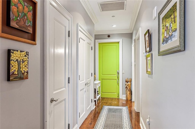 hall with crown molding and hardwood / wood-style flooring