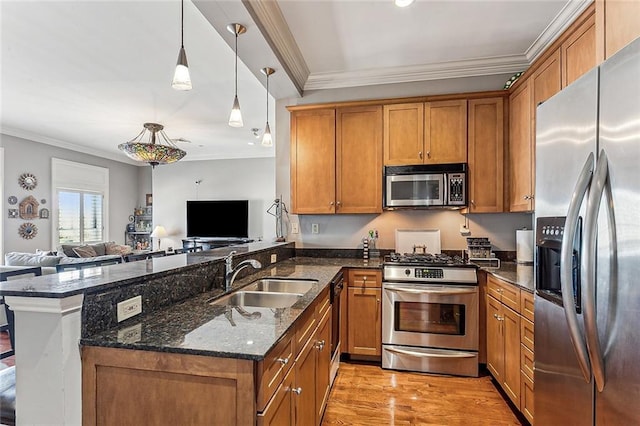 kitchen featuring kitchen peninsula, stainless steel appliances, light hardwood / wood-style floors, dark stone counters, and sink