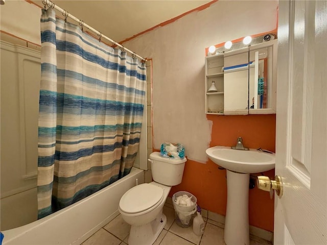 bathroom with tile patterned flooring, shower / bath combo, and toilet