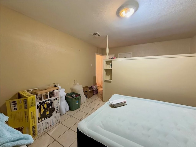 bedroom featuring light tile patterned floors