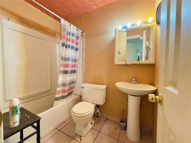 full bathroom with tile patterned floors, toilet, sink, and shower / tub combo with curtain