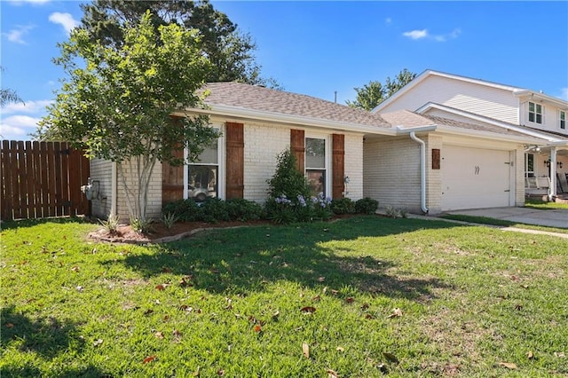 view of front facade with a garage and a front yard