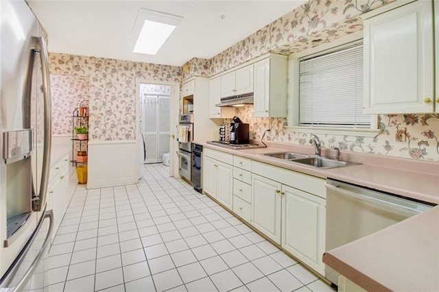 kitchen featuring appliances with stainless steel finishes, light tile floors, and sink