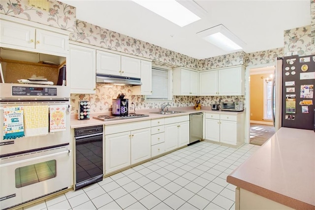 kitchen with white cabinets, sink, stainless steel appliances, and light tile floors